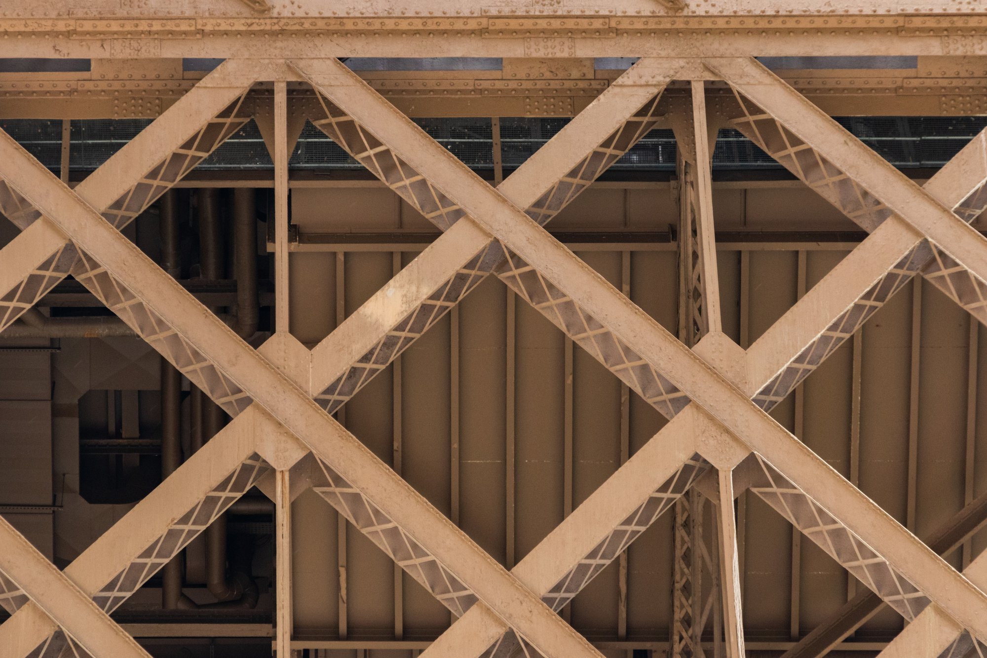 Beige crisscross structural steel detail.